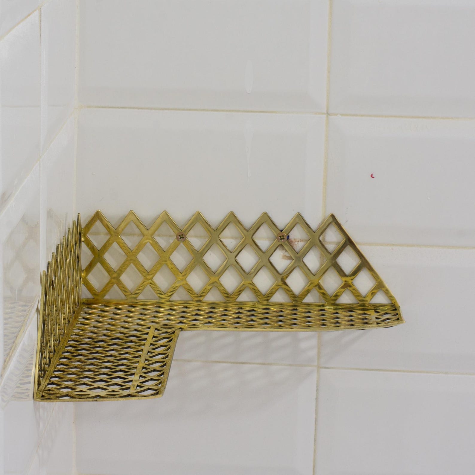 Experience authentic craftsmanship With Insideast Solid Brass Double Grid Corner Shelf that will develop natural patina with time.