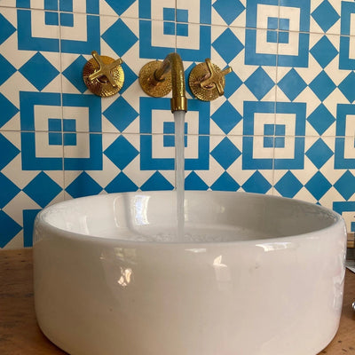 Hammered brass vintage wall-mount sink faucet — the type Christopher S. purchased for his own home