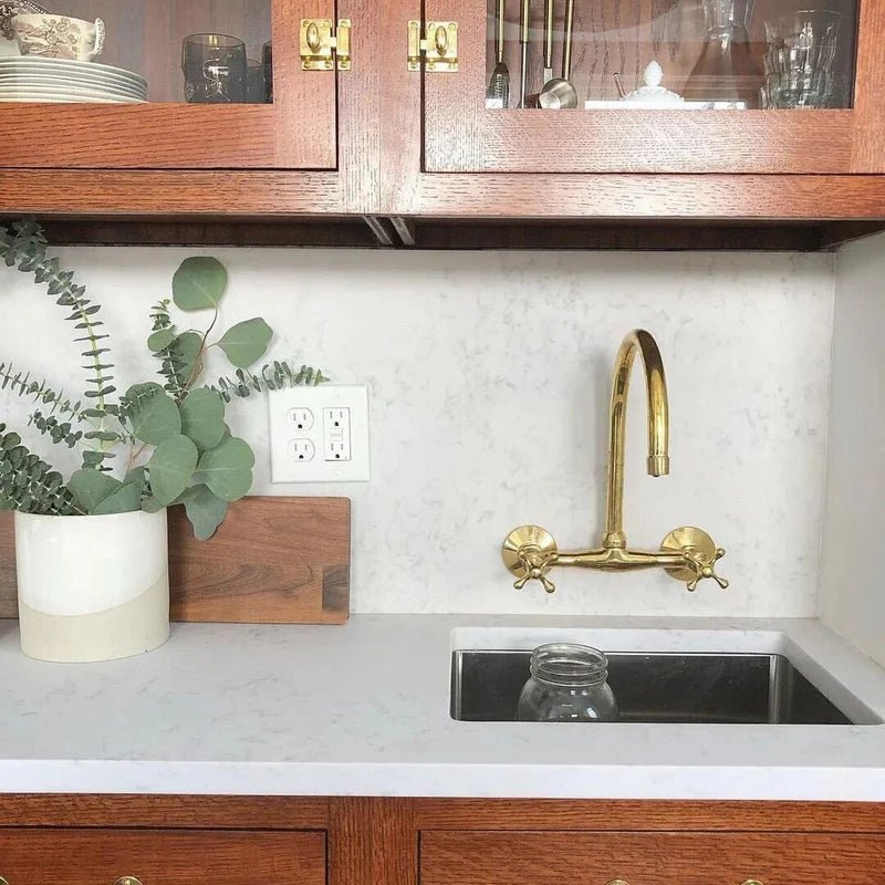 Unlacquered brass gooseneck bridge faucet on a farmhouse apron sink