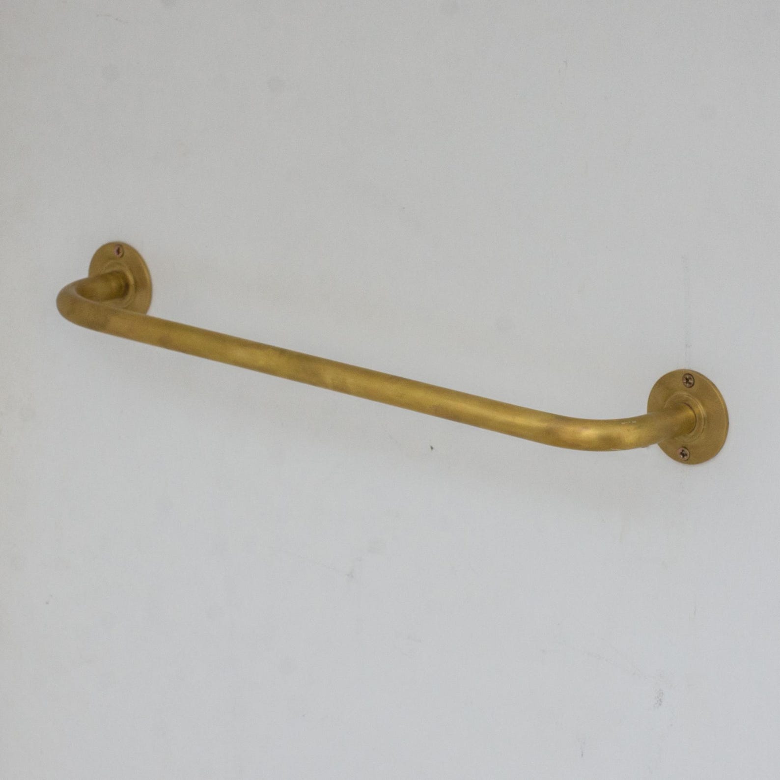 Experience authentic craftsmanship With Insideast Unlacquered Brass Towel Bar Holder that develops warm patina over time.