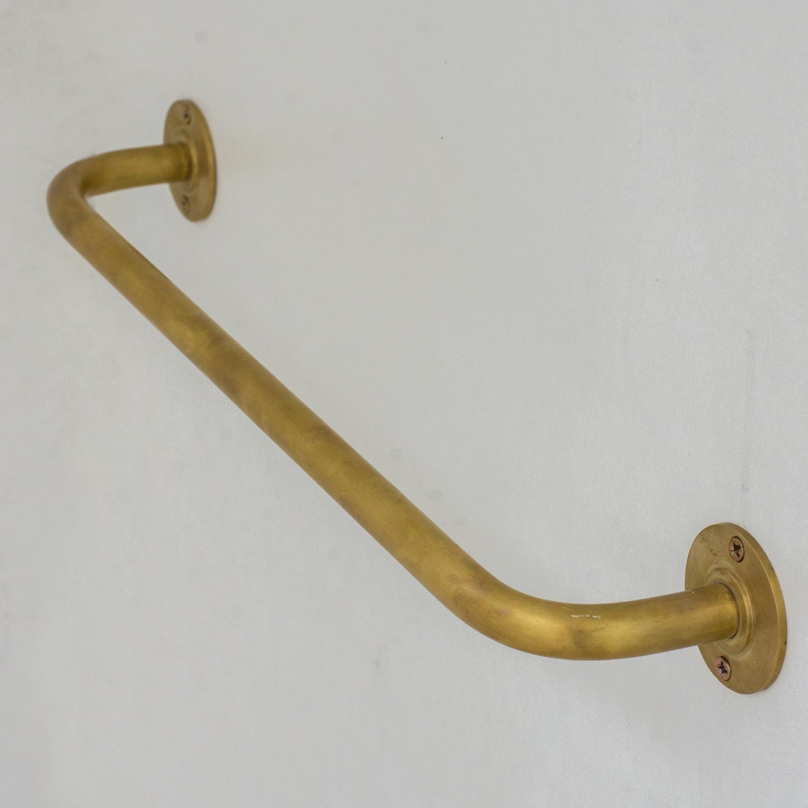 Experience authentic craftsmanship With Insideast Unlacquered Brass Towel Bar Holder that develops warm patina over time.