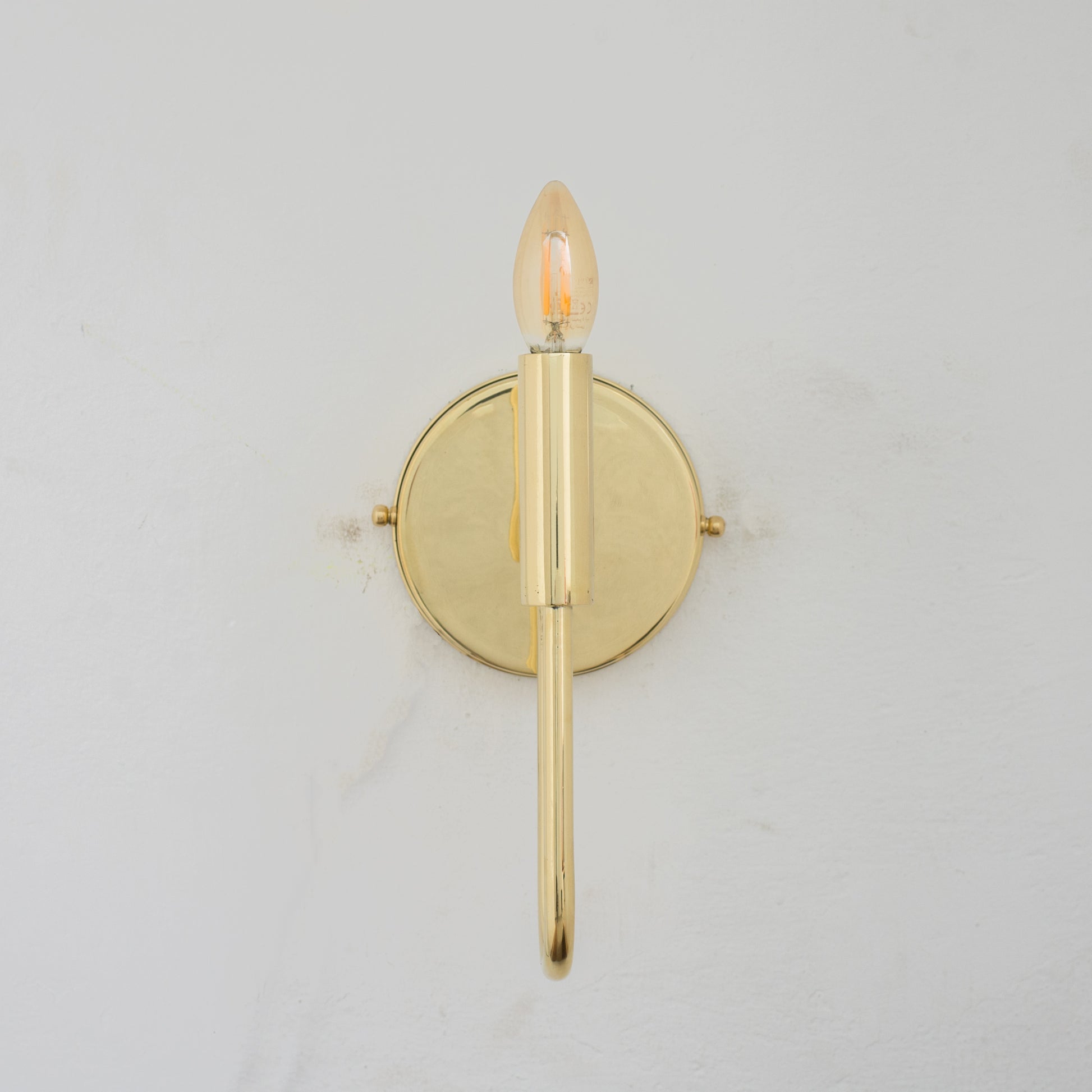 Experience authentic craftsmanship With our Unlacquered Brass Arch Sconce Light that will develops natural patina with time.