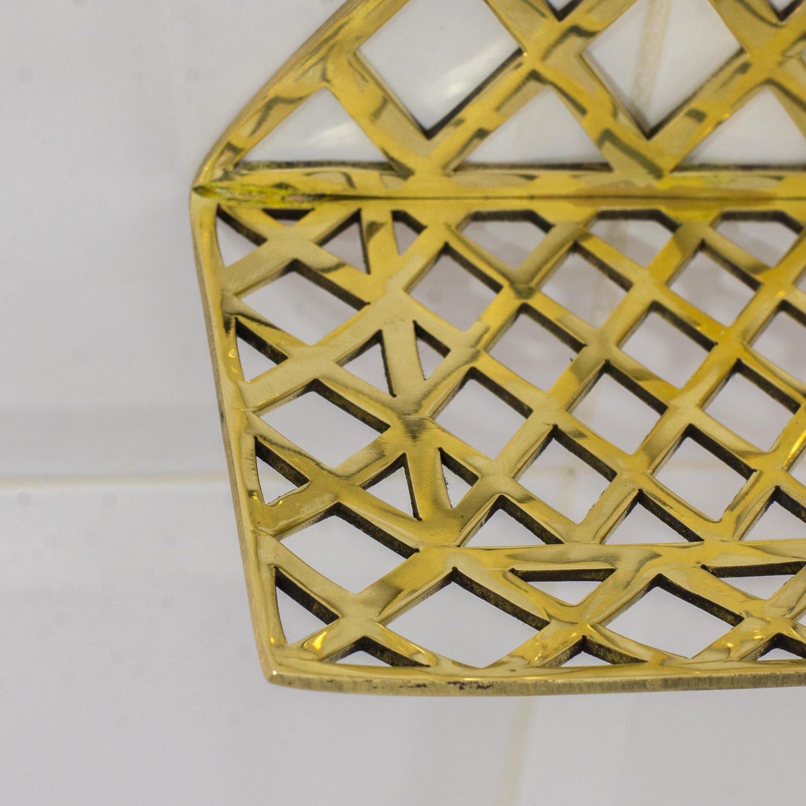 Experience authentic craftsmanship With Insideast Solid Brass Double Grid Corner Shelf that will develop natural patina with time.