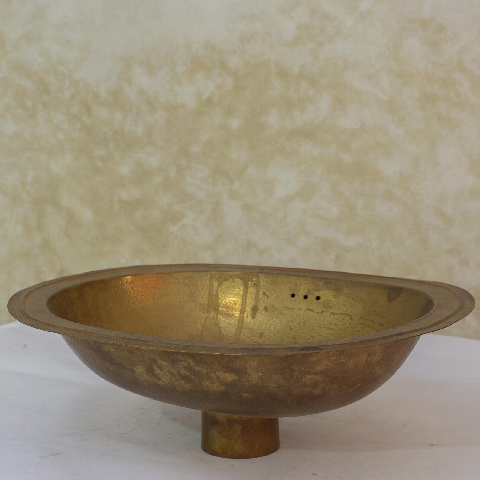 Vintage hammered brass oval sink detail