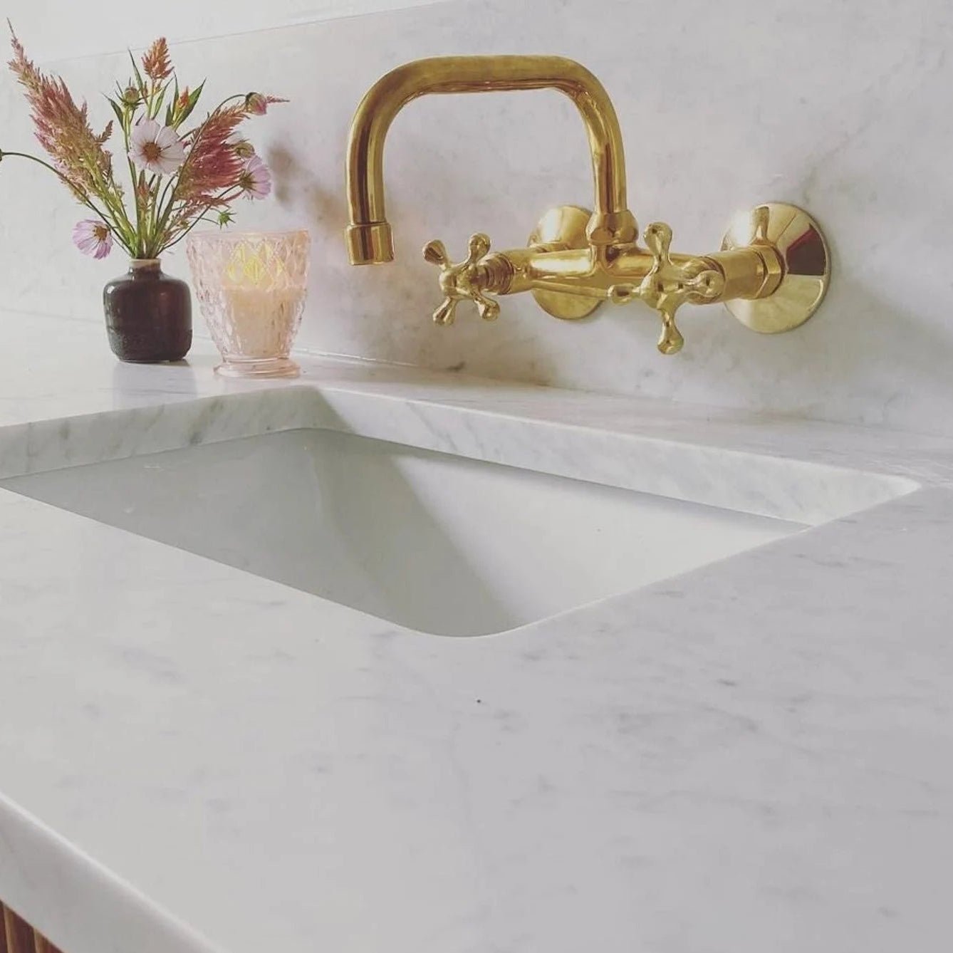 Vintage unlacquered brass kitchen faucet with a swiveling spout