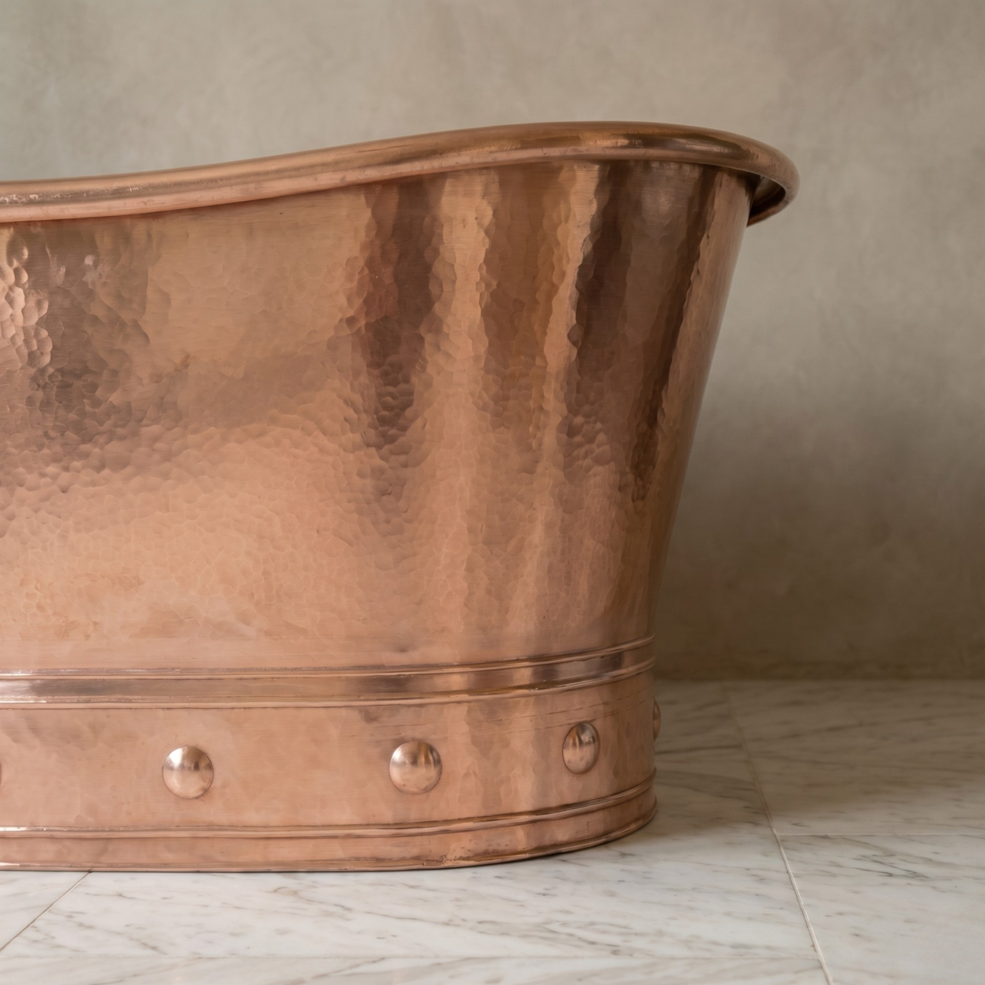 Close-up of hand-hammered solid copper bathtub surface showing natural living finish