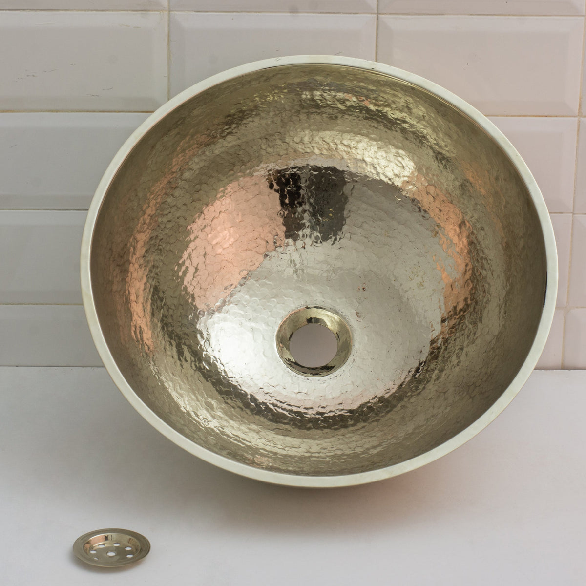 German silver bowl vessel sink on a bathroom vanity