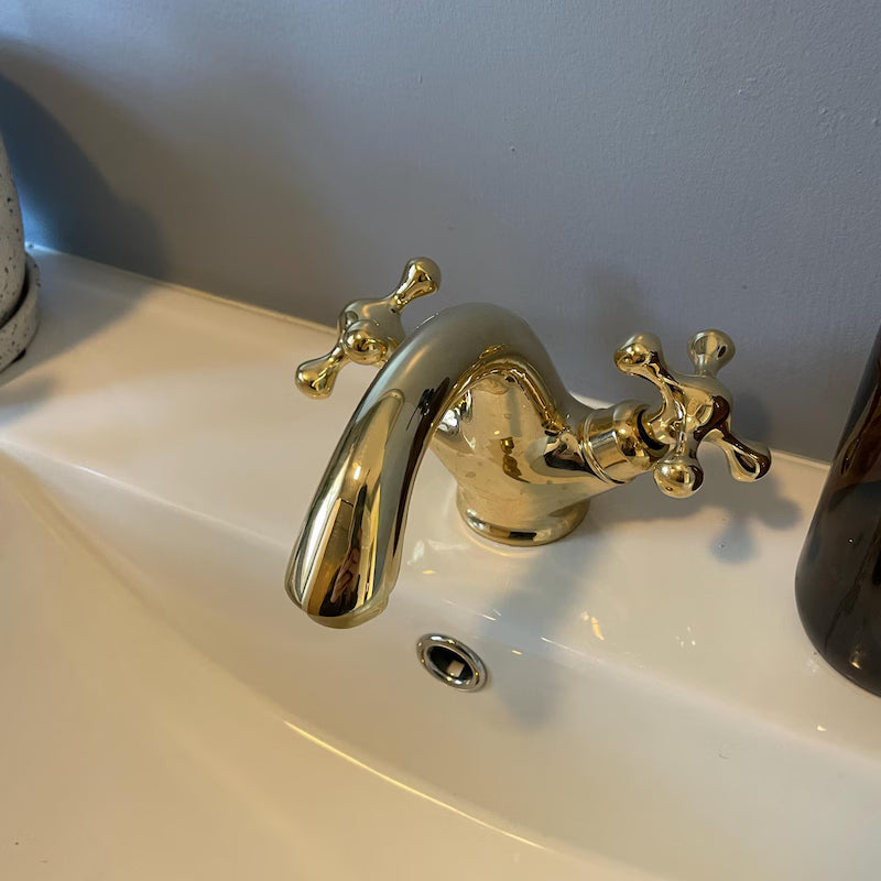 Single-hole unlacquered brass bathroom vanity faucet with simple cross handles