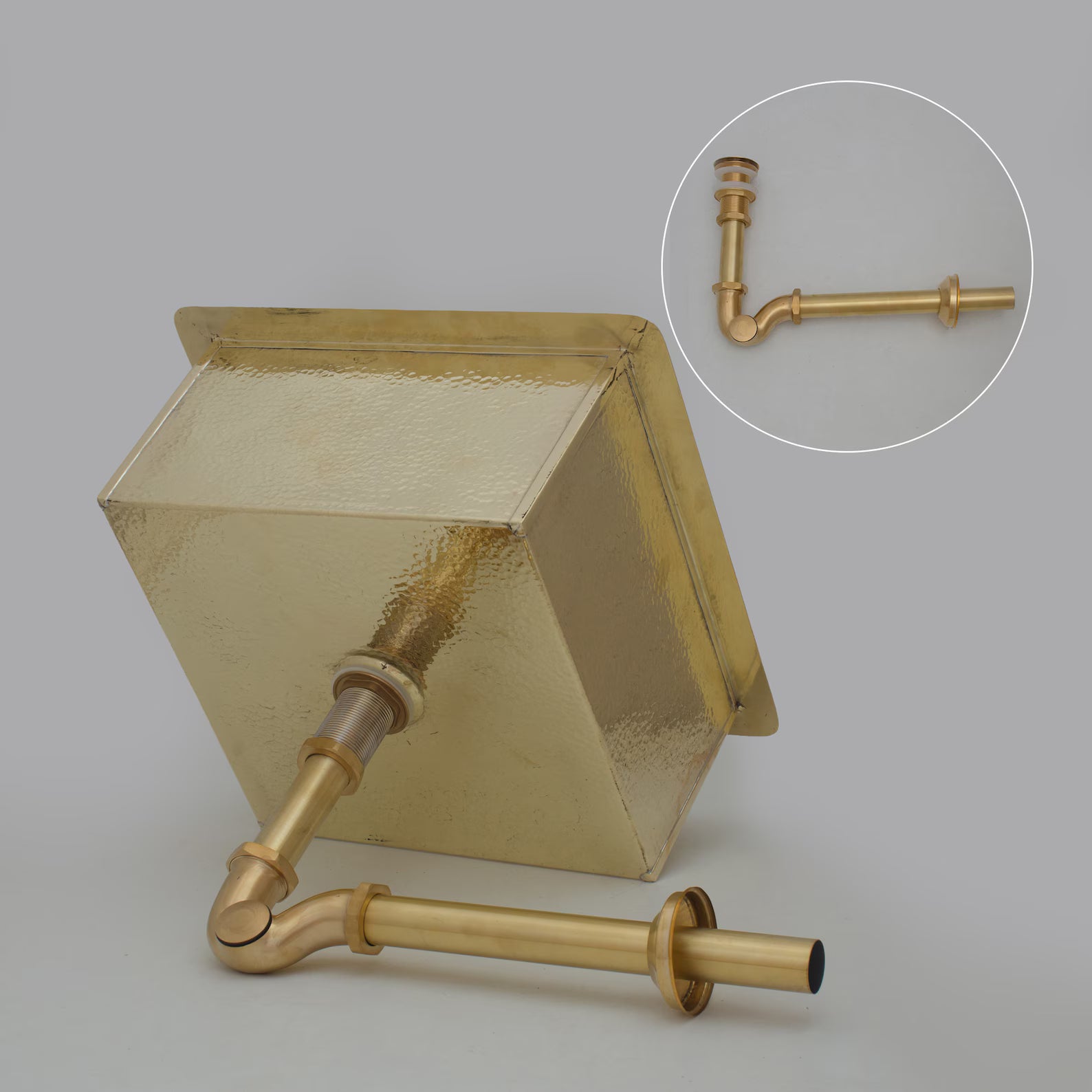 Brass sink undermount installation detail — clean sealed corners, drain opening