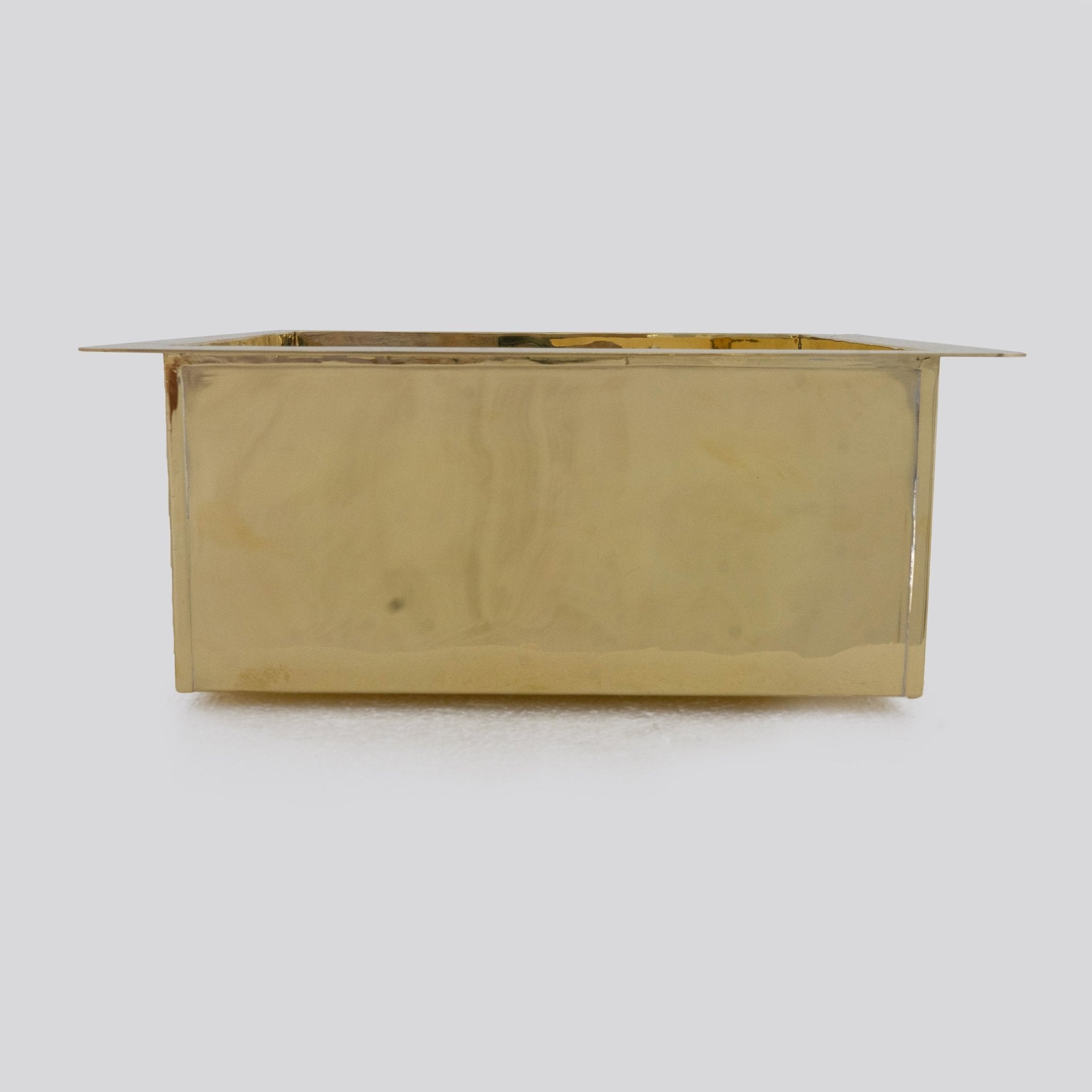 Brass sink undermount installation from below — clean lip and corner detail