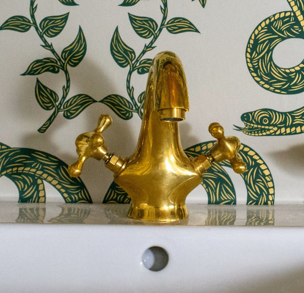 Unlacquered brass single-hole bathroom sink vanity faucet with double cross handles