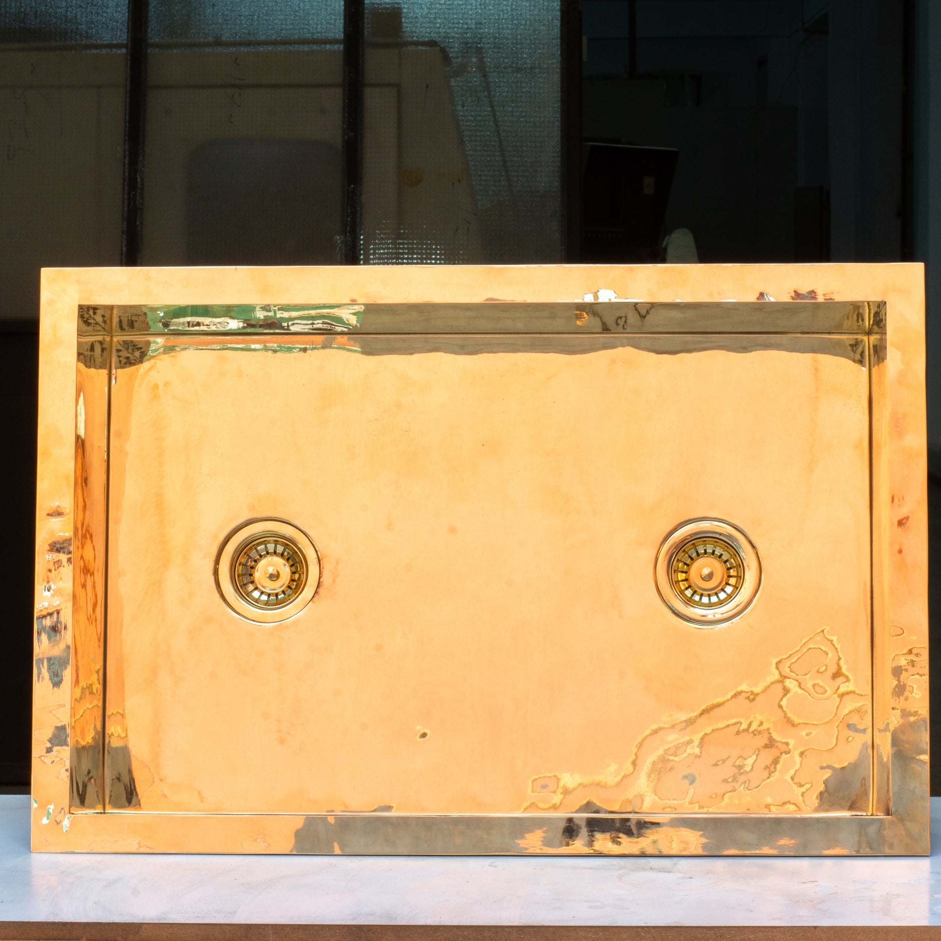 Smooth unlacquered brass farmhouse kitchen sink with double drain