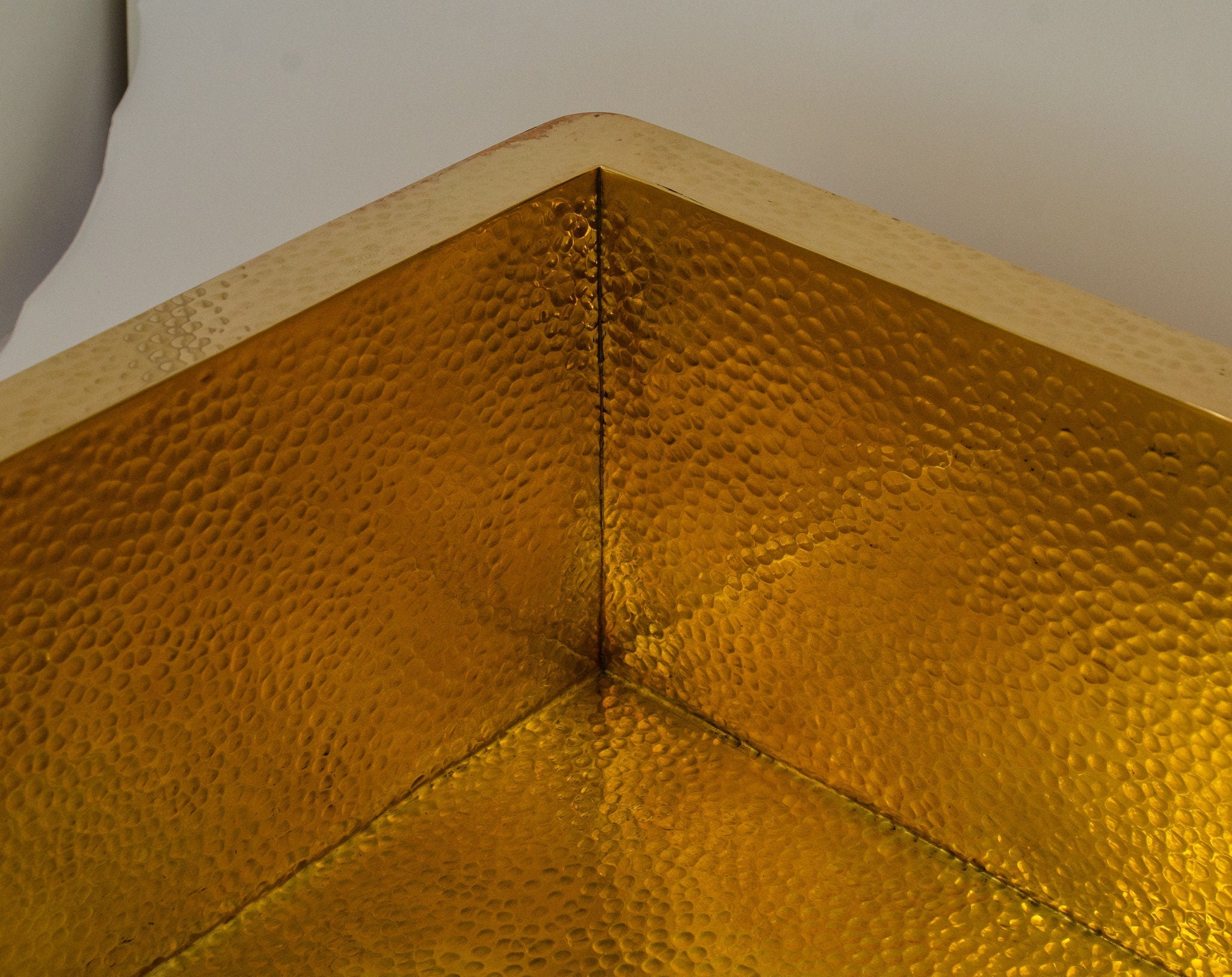 Hammered brass sink overhead view — texture detail and uniform hammering pattern