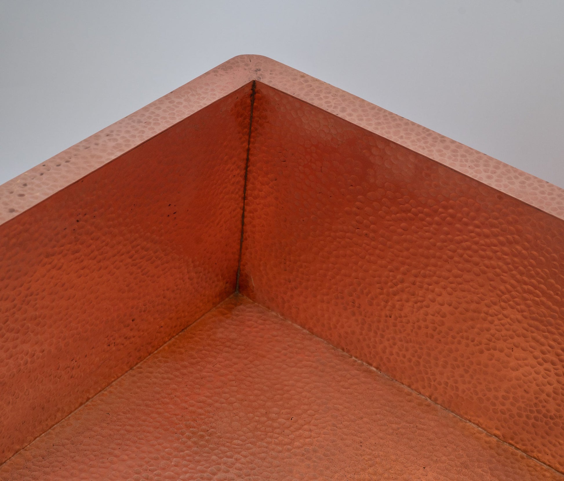 Close-up of copper hammered sink texture — hand-forged surface detail Marrakesh artisan