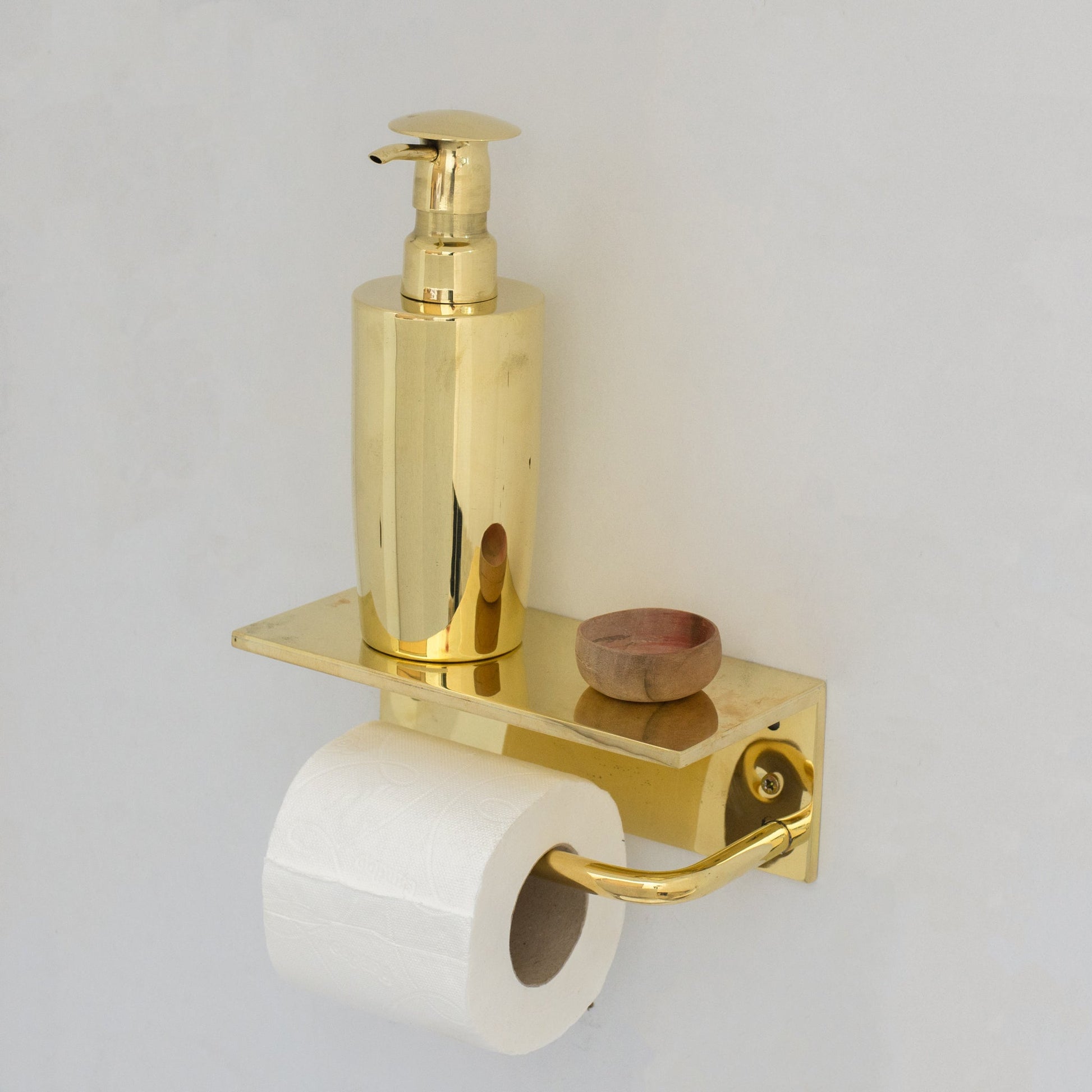 Unlacquered brass floating shelf with hook and toilet paper holder