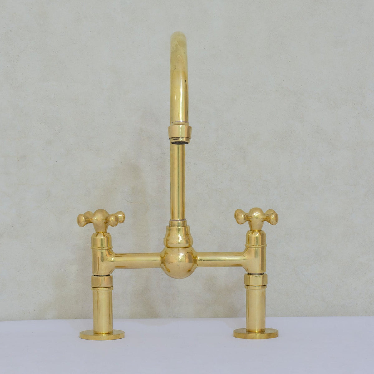 Unlacquered brass bridge kitchen faucet handle detail