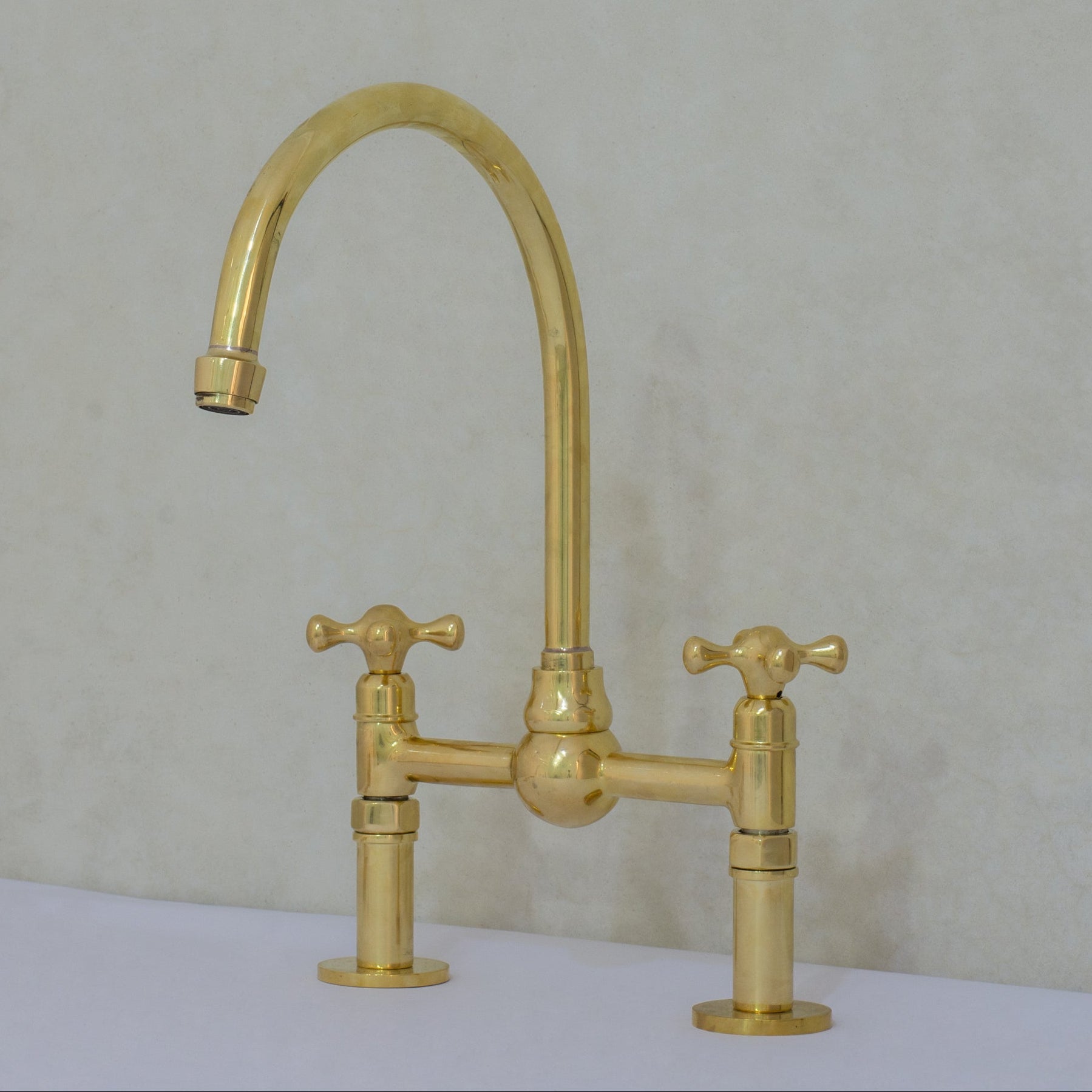 Unlacquered brass bridge kitchen faucet with simple cross handles