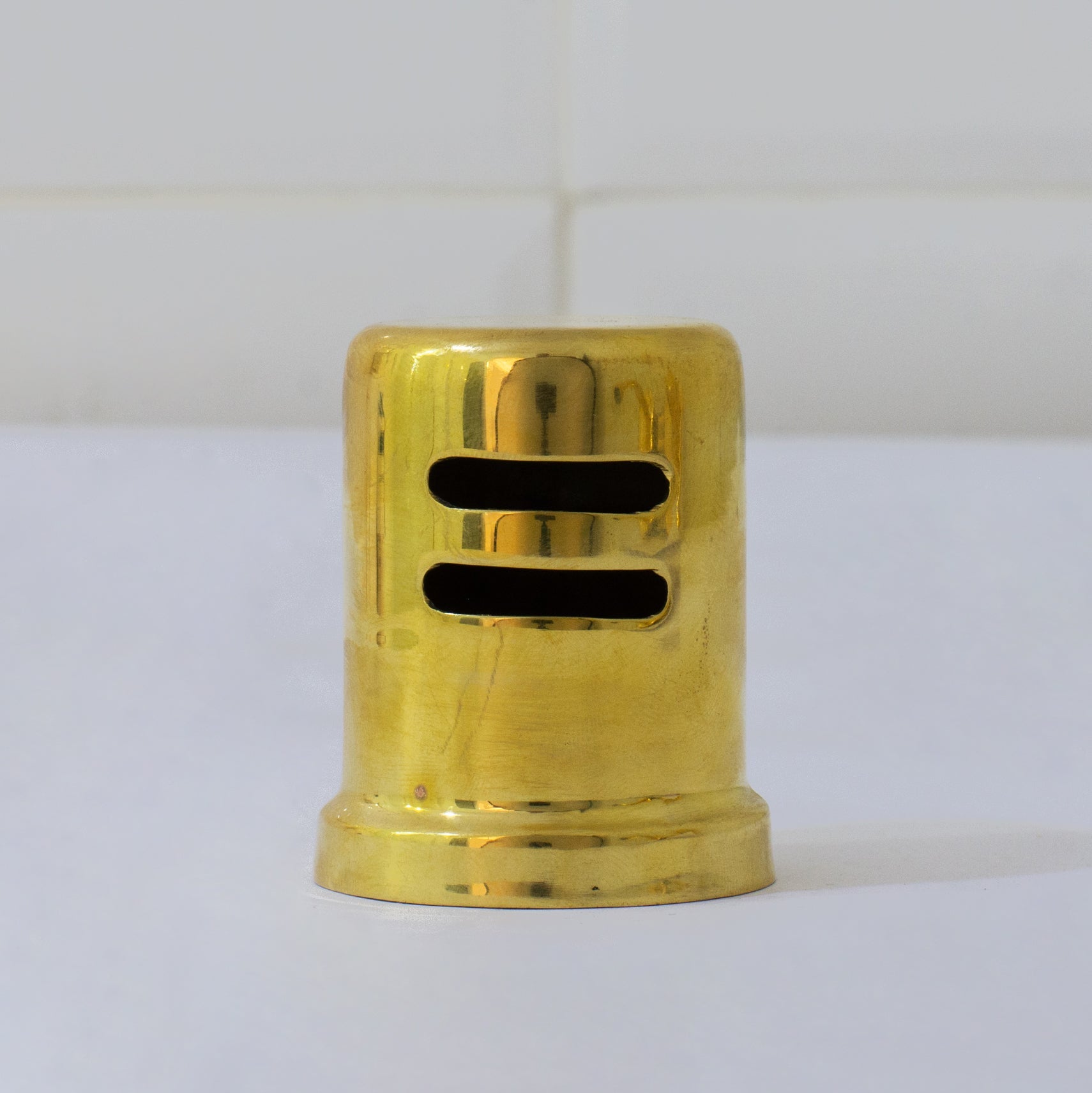 Unlacquered brass dishwasher air gap cover with a skirted cap