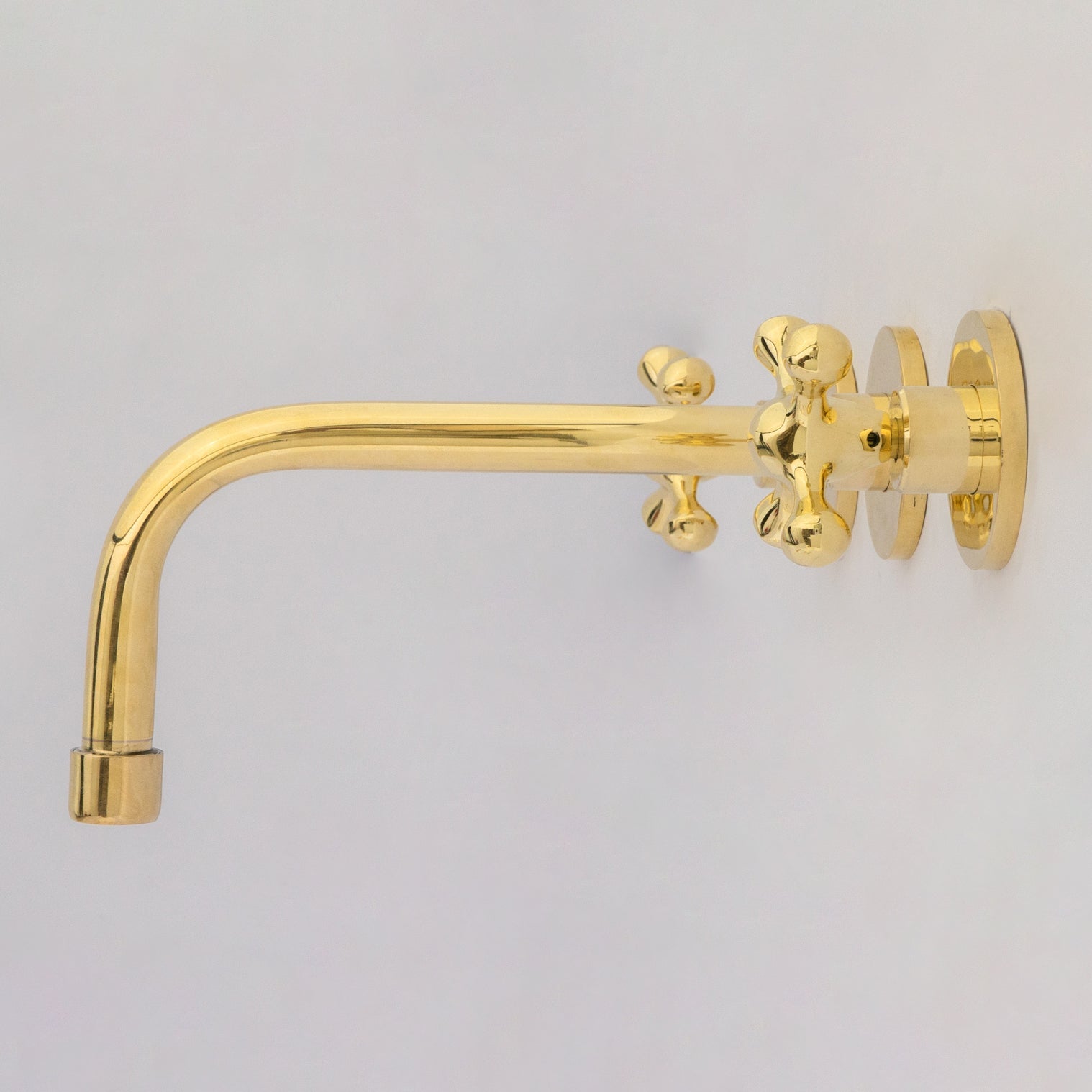 Unlacquered brass wall mounted vessel sink faucet side view