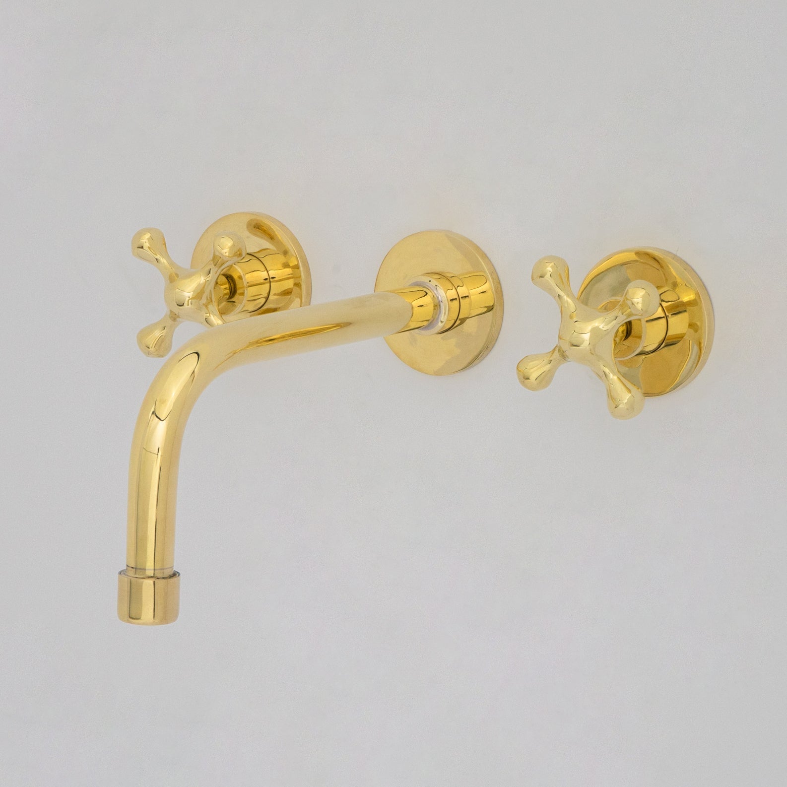 Unlacquered brass wall mounted vessel sink faucet front view