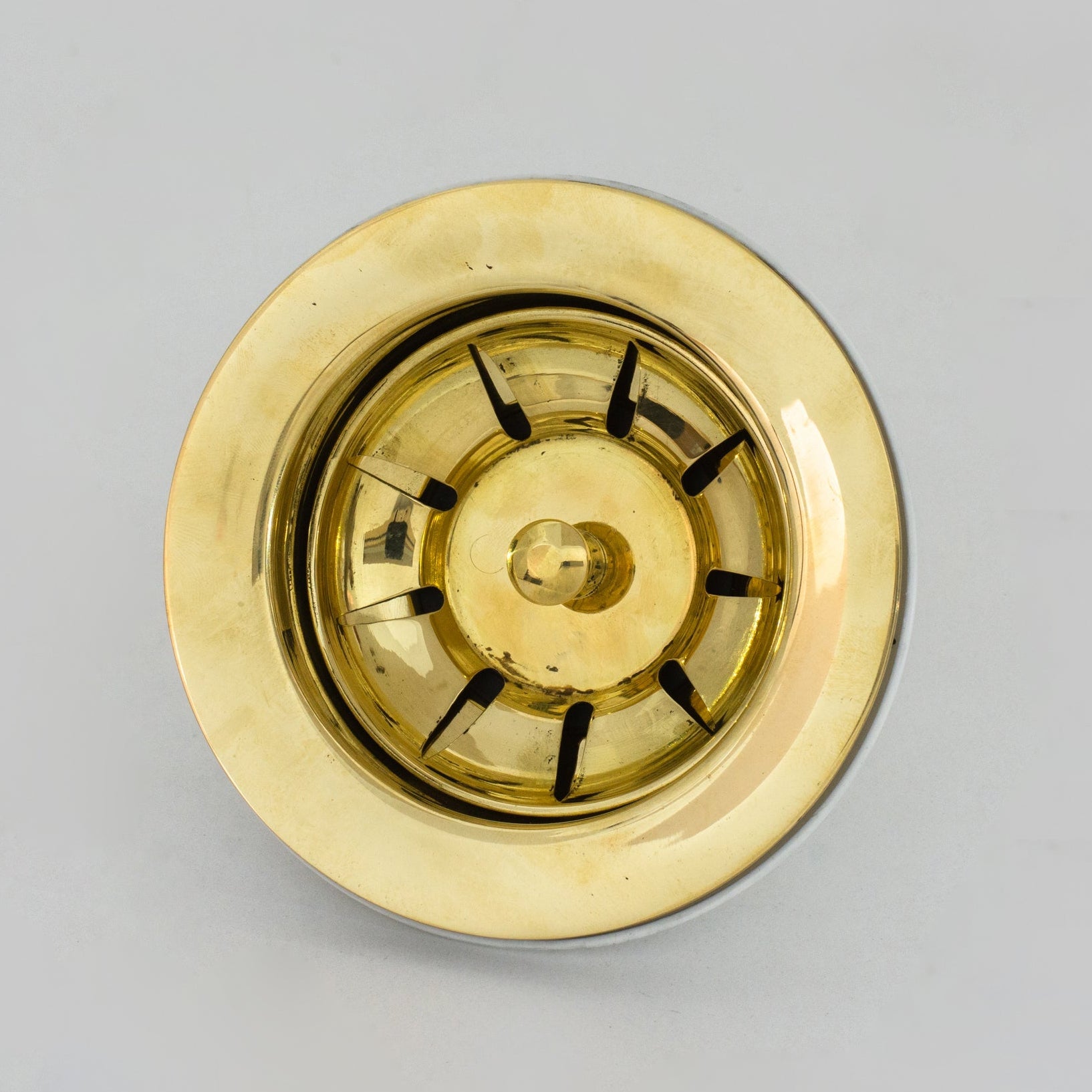 Unlacquered brass kitchen strainer basket for a sink drain